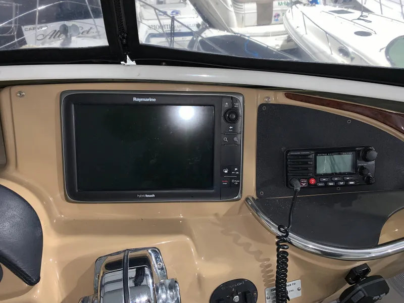 Slide: The Image of Control panel of a 2001 Carver 396 Motor Yacht with navigation and communication equipment. - 13