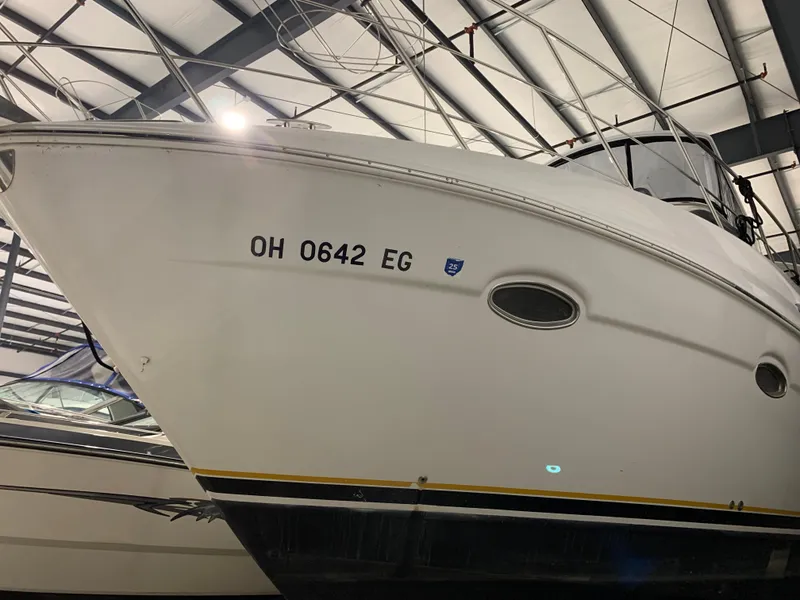 Slide: The Image of 2001 Carver 396 Motor Yacht in storage, displaying registration number OH 0642 EG. - 2