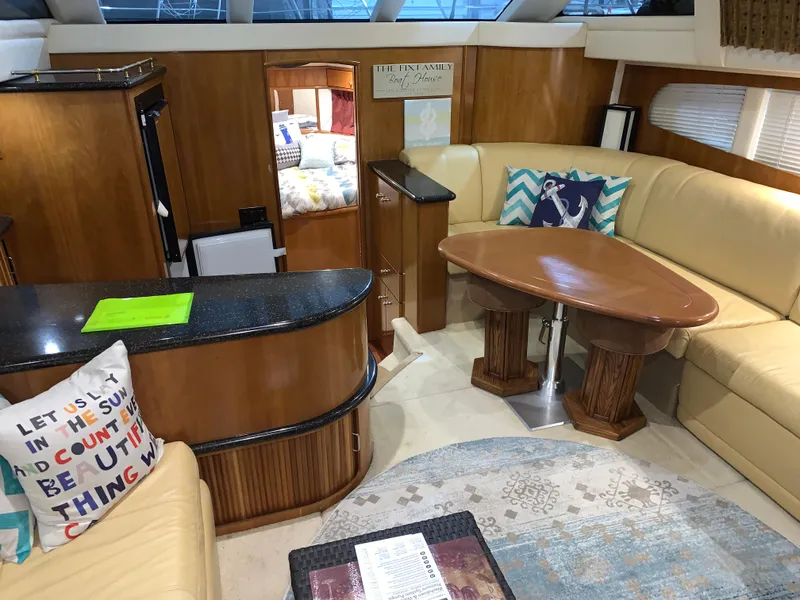 Slide: The Image of Luxurious interior of 2001 Carver 396 Motor Yacht with elegant seating and wooden accents. - 25