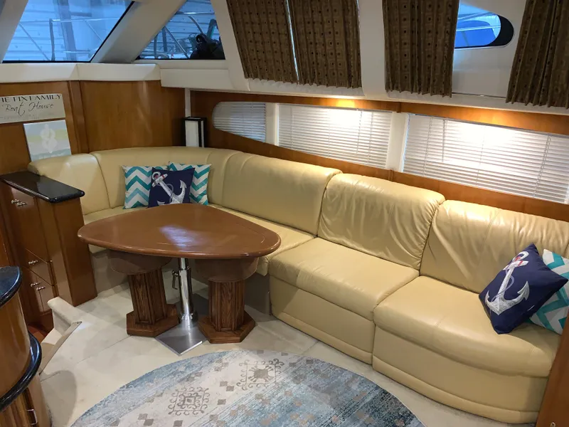 Slide: The Image of Luxurious interior of 2001 Carver 396 Motor Yacht with leather seating and nautical decor. - 26