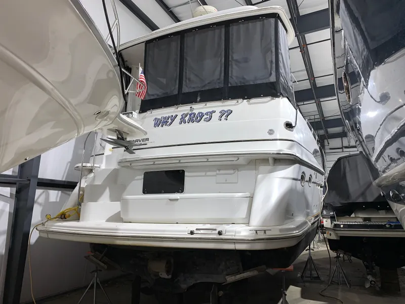 Slide: The Image of 2001 Carver 396 Motor Yacht in storage, rear view with American flag. - 4