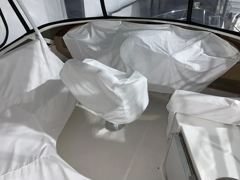 Slide: The Image of 2001 Carver 396 Motor Yacht interior with covered seating and helm, showcasing spacious design. - 9