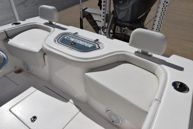 Slide: The Image of 2024 Contender 24 Sport boat interior with cushioned seating and storage. - 10