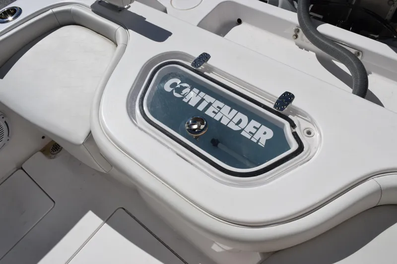 Slide: The Image of 2024 Contender 24 Sport boat interior with branded compartment lid. - 13