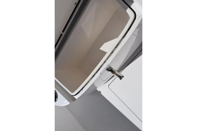 Slide: The Image of Open storage compartment on 2024 Contender 24 Sport boat, showcasing interior space. - 15