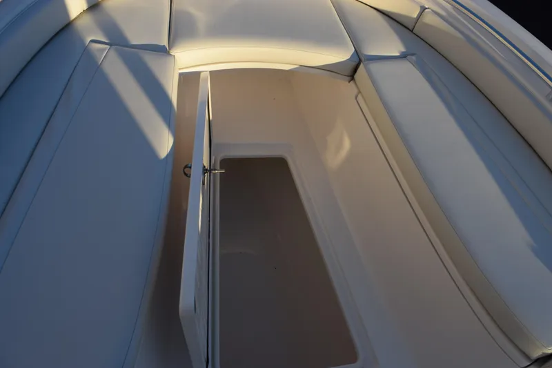 Slide: The Image of 2024 Contender 24 Sport boat interior storage compartment with open hatch. - 18