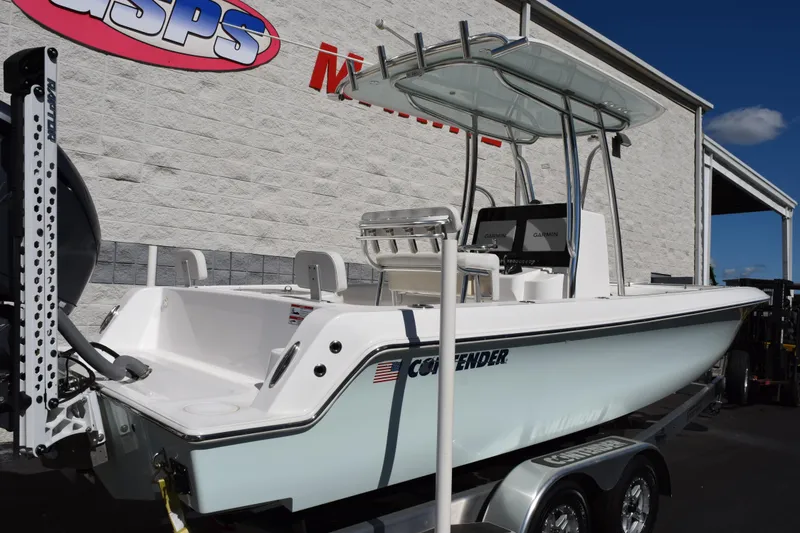 Slide: The Image of 2024 Contender 24 Sport boat on trailer, displayed outdoors at dealership. - 2