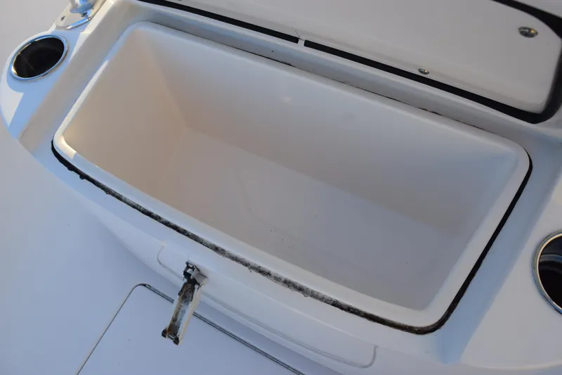 Slide: The Image of Open storage compartment on 2024 Contender 24 Sport boat, featuring cup holders. - 20