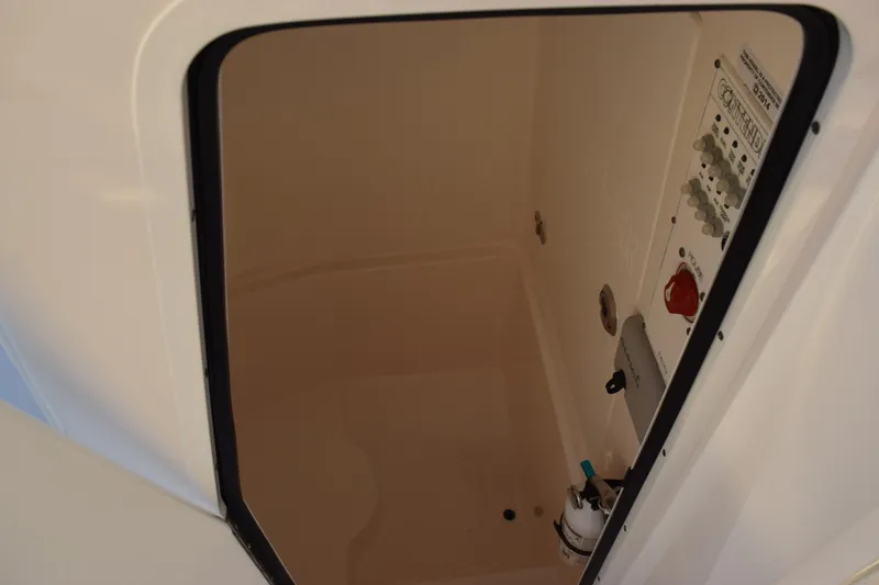Slide: The Image of 2024 Contender 24 Sport boat compartment with control panel and wiring. - 21