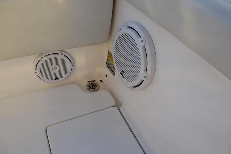 Slide: The Image of 2024 Contender 24 Sport boat interior with built-in speakers and drainage system. - 24