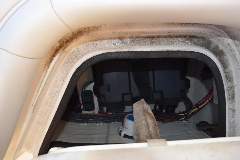 Slide: The Image of 2024 Contender 24 Sport boat interior wiring and battery compartment. - 25