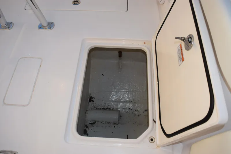 Slide: The Image of 2024 Contender 24 Sport boat storage compartment with open hatch. - 26