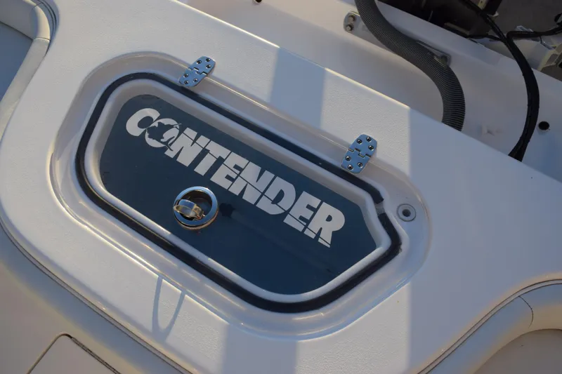 Slide: The Image of 2024 Contender 24 Sport boat hatch with logo and latch detail. - 27