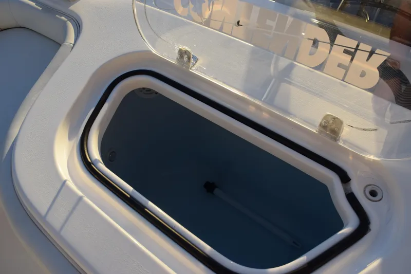 Slide: The Image of 2024 Contender 24 Sport boat livewell with open lid, showcasing interior design. - 28