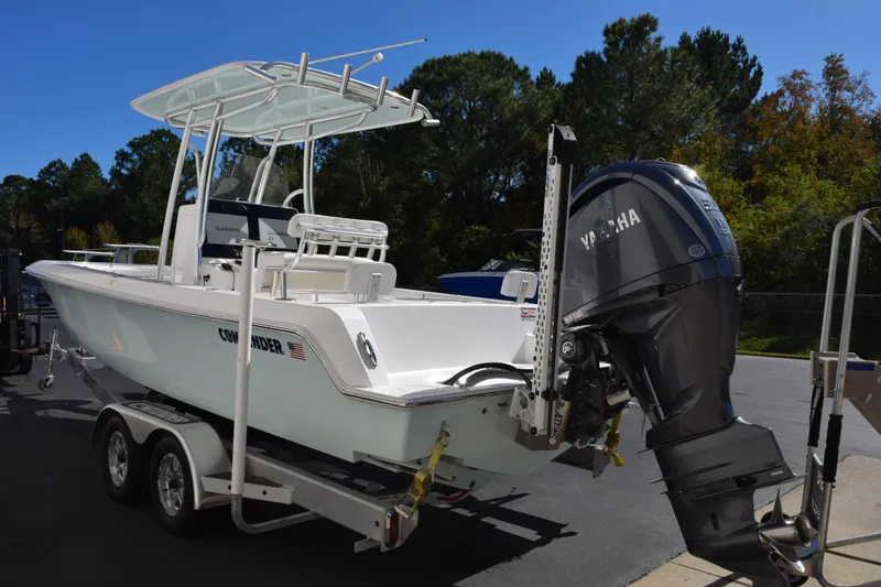 Slide: The Image of 2024 Contender 24 Sport boat with Yamaha engine on trailer, parked outdoors. - 5
