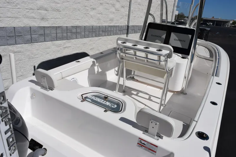 Slide: The Image of 2024 Contender 24 Sport boat interior with Garmin displays and seating. - 7
