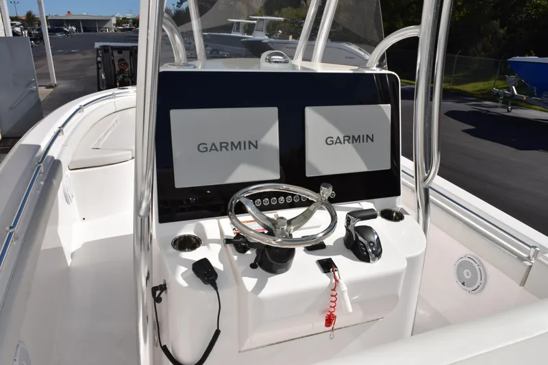 Slide: The Image of 2024 Contender 24 Sport boat dashboard with dual Garmin displays and steering wheel. - 8