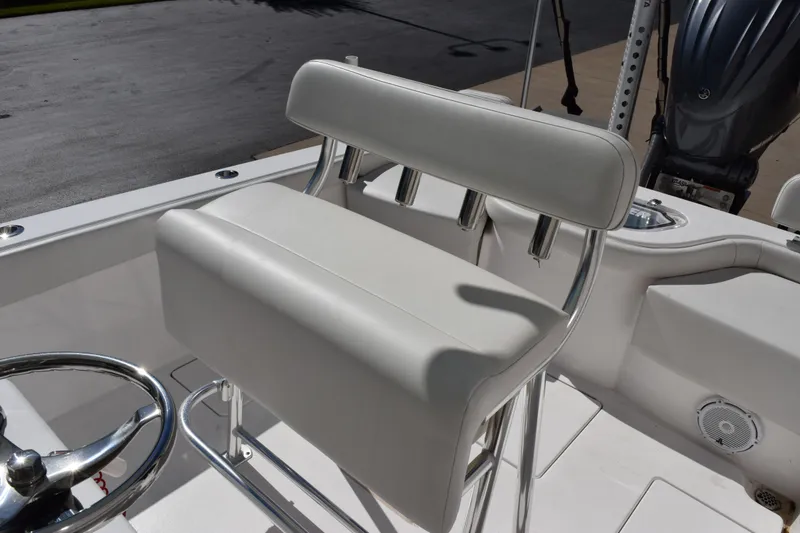 Slide: The Image of 2024 Contender 24 Sport boat helm seat with rod holders and steering wheel. - 9