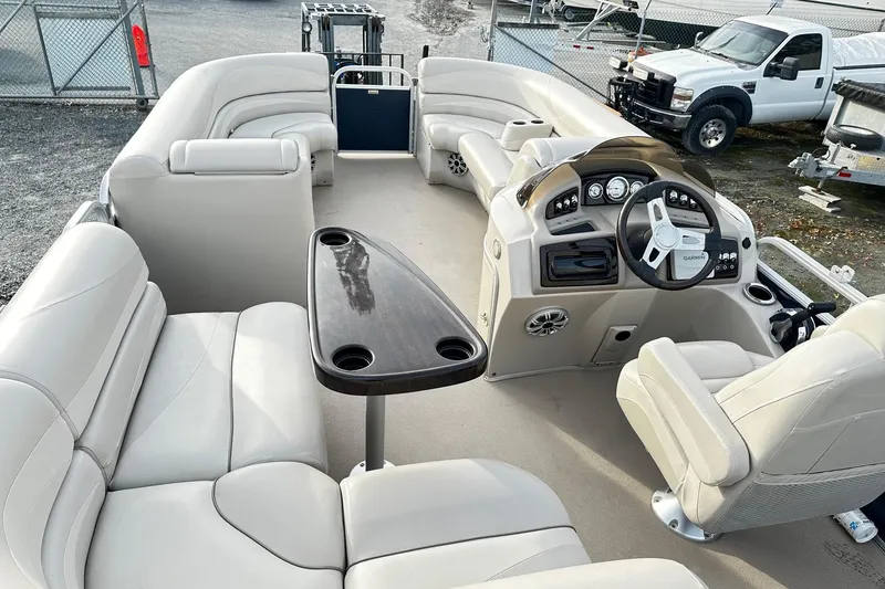 Slide: The Image of 2015 Bennington 2275GS Pontoon boat interior with plush seating and modern dashboard. - 11