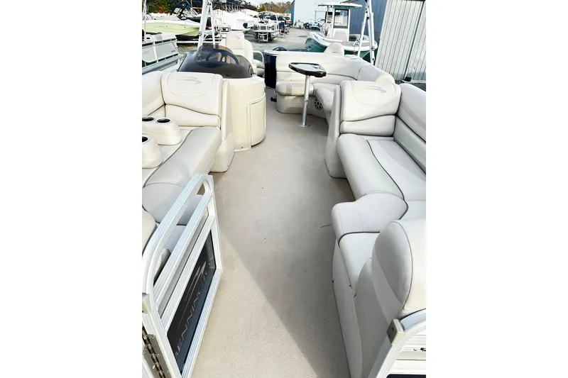 Slide: The Image of 2015 Bennington 2275GS Pontoon boat interior with spacious seating and table. - 12