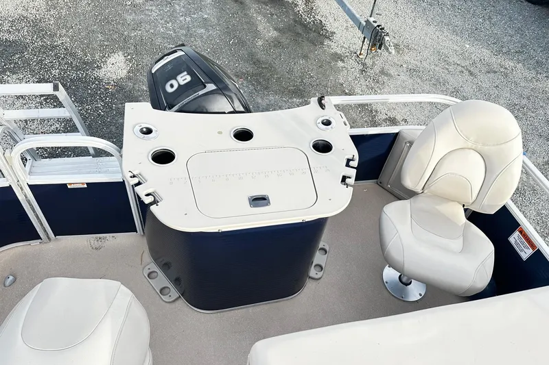 Slide: The Image of 2015 Bennington 2275GS Pontoon boat interior with seating and motor view. - 17