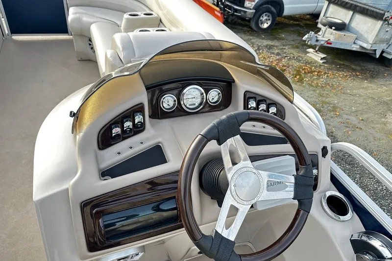 Slide: The Image of 2015 Bennington 2275GS Pontoon boat dashboard with steering wheel and gauges. - 4