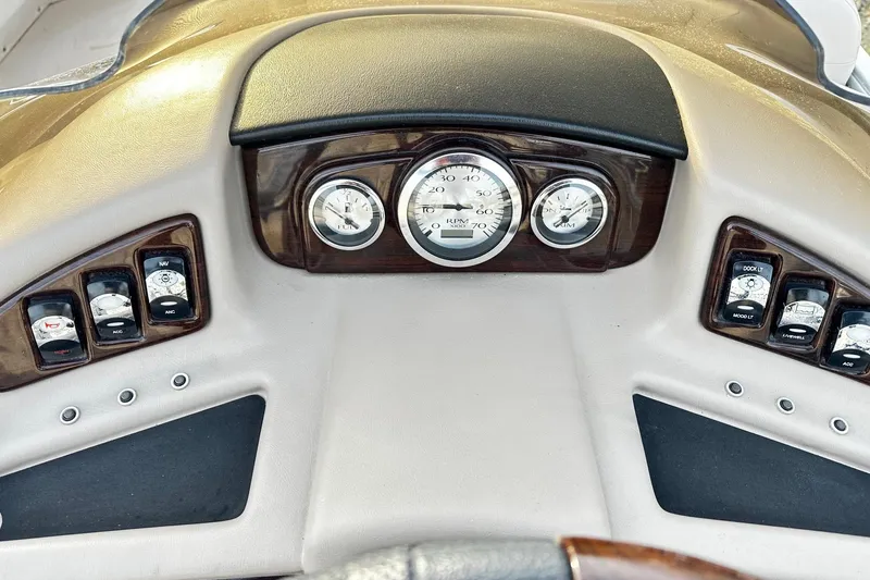 Slide: The Image of 2015 Bennington 2275GS Pontoon dashboard with gauges and control switches. - 7