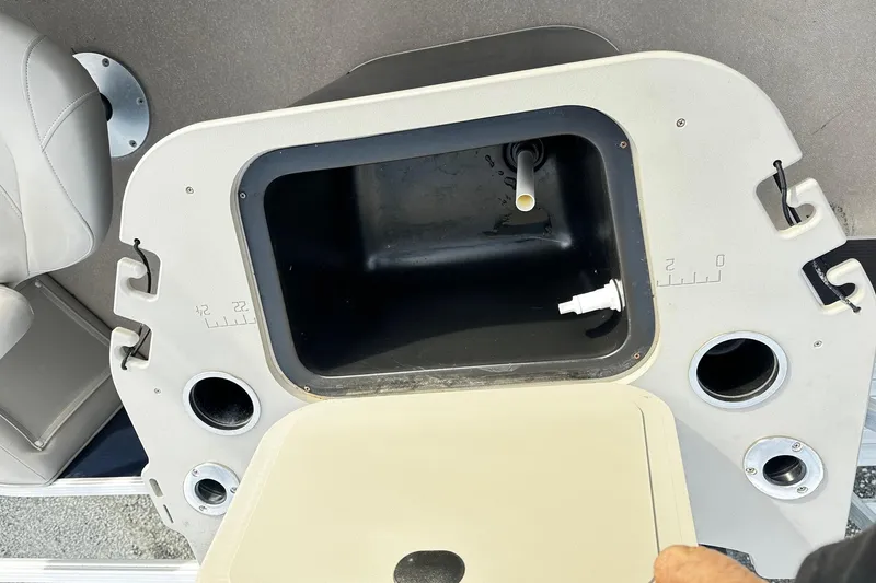 Slide: The Image of Open storage compartment on 2015 Bennington 2275GS Pontoon boat, showing interior details. - 9
