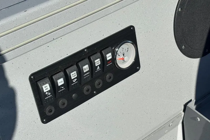 Slide: The Image of Control panel of 2026 Smoker Craft Pro Sportsman 2072 T boat with switches and fuel gauge. - 3