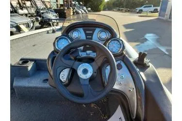 Slide: The Image of 2023 Tracker Pro Team 175 TXW boat dashboard with steering wheel and gauges. - 2