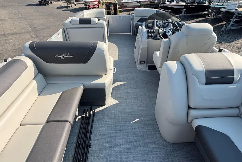 Slide: The Image of 2024 SunChaser Geneva Cruise 22 LR PSB pontoon boat interior with plush seating and modern dashboard. - 6