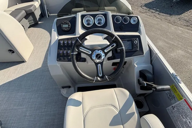 Slide: The Image of 2024 SunChaser Geneva Cruise 22 LR PSB boat dashboard with steering wheel and controls. - 7