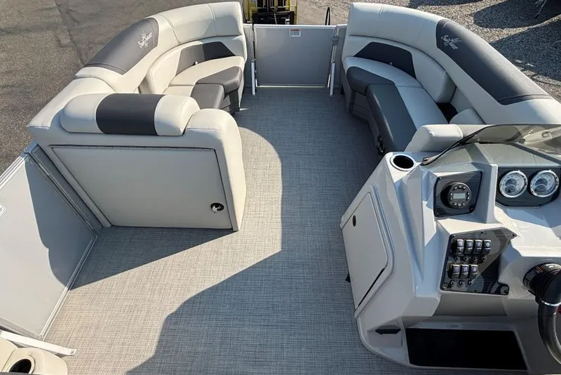 Slide: The Image of 2024 SunChaser Geneva Cruise 22 LR PSB pontoon boat interior with plush seating and modern dashboard. - 8