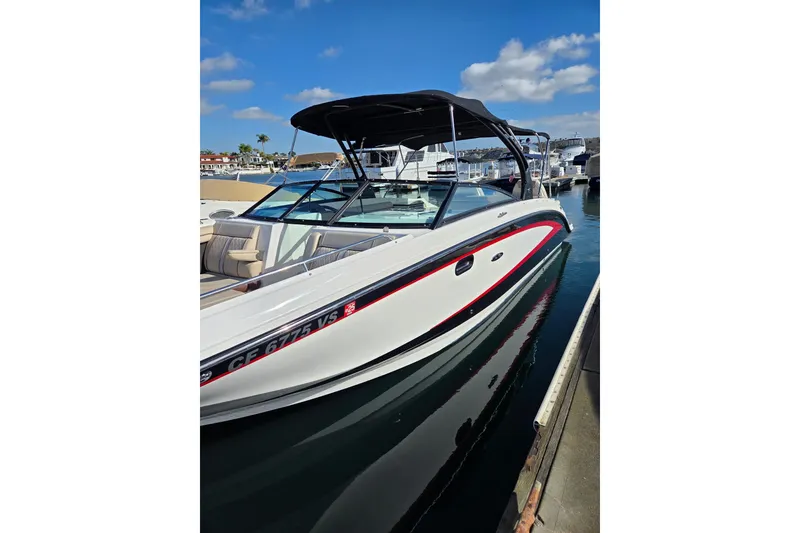The Image of 2016 Sea Ray SDX 290 boat docked in a sunny marina setting. - 0
