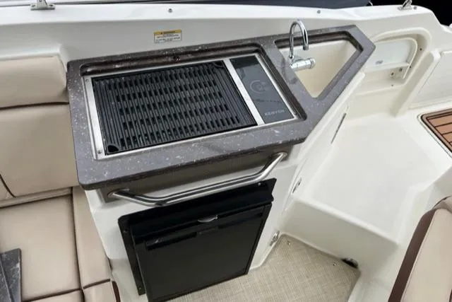 Slide: The Image of Outdoor kitchen area on a 2016 Sea Ray SDX 290 boat with grill and sink. - 15