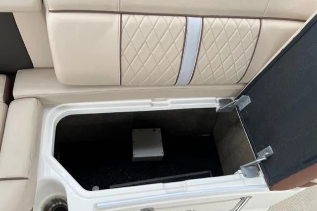 Slide: The Image of 2016 Sea Ray SDX 290 boat storage compartment with quilted beige seating. - 16