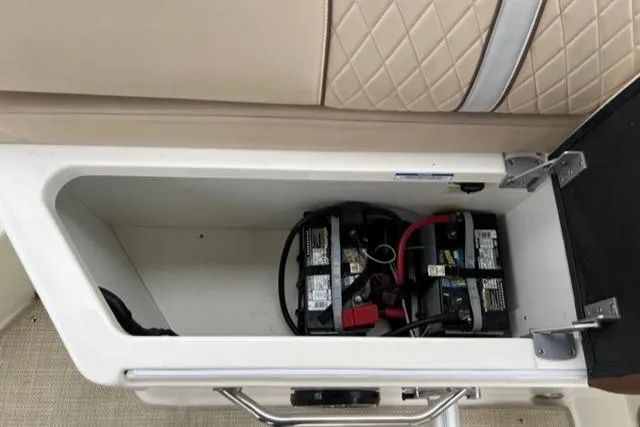 Slide: The Image of Battery compartment of a 2016 Sea Ray SDX 290 boat, featuring dual batteries. - 17