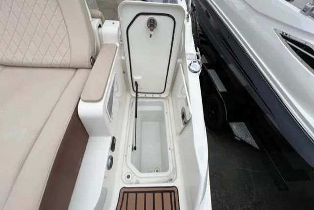 Slide: The Image of Interior view of a 2016 Sea Ray SDX 290 boat, featuring storage compartment and seating. - 18