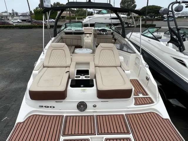 Slide: The Image of 2016 Sea Ray SDX 290 boat interior with seating and table, docked at marina. - 2