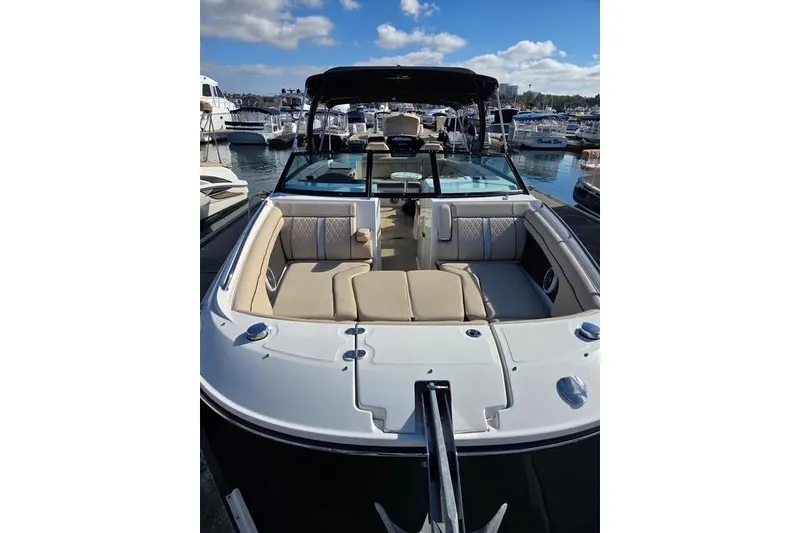 Slide: The Image of 2016 Sea Ray SDX 290 boat docked at marina, featuring spacious seating and sleek design. - 20