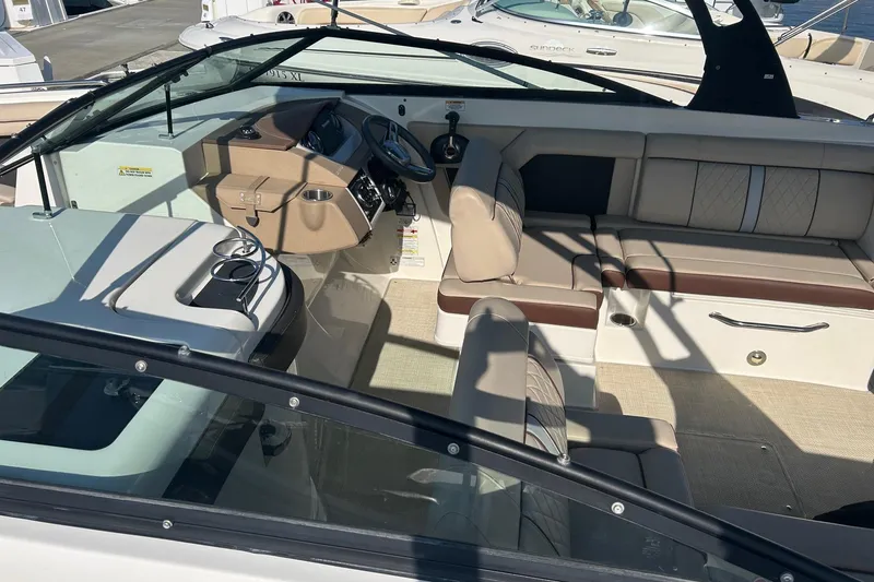 Slide: The Image of Interior of a 2016 Sea Ray SDX 290 boat with beige seating and steering console. - 22