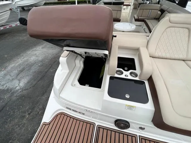Slide: The Image of 2016 Sea Ray SDX 290 boat interior with open storage compartment and seating area. - 3