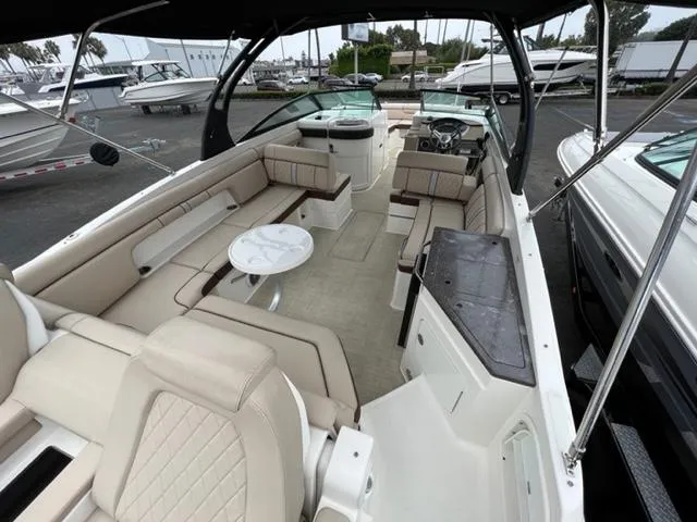 Slide: The Image of 2016 Sea Ray SDX 290 boat interior with spacious seating and modern design. - 4