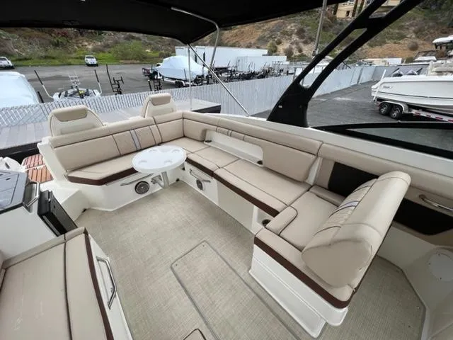 Slide: The Image of Luxurious seating area on a 2016 Sea Ray SDX 290 boat, featuring beige upholstery. - 5