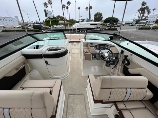 Slide: The Image of Interior view of 2016 Sea Ray SDX 290 boat with beige seating and steering console. - 6