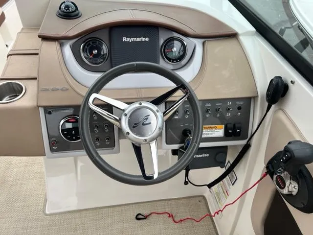 Slide: The Image of 2016 Sea Ray SDX 290 dashboard with steering wheel and Raymarine controls. - 8