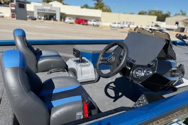 Slide: The Image of 2026 Vexus AVX181 boat interior with steering wheel and dual seats in a parking lot. - 3