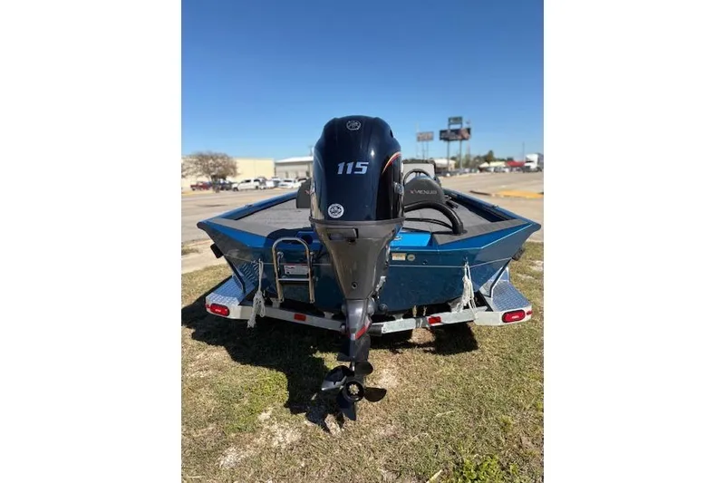 Slide: The Image of 2026 Vexus AVX181 boat with 115 horsepower engine, parked on grass. - 4