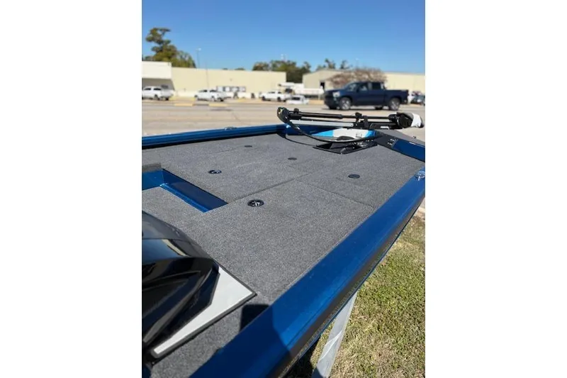 Slide: The Image of 2026 Vexus AVX181 boat deck with blue trim, parked outdoors. - 6