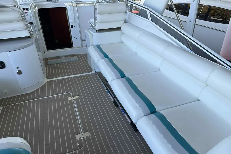 Slide: The Image of 1993 Mainship 39 Express interior with white seating and striped flooring. - 10